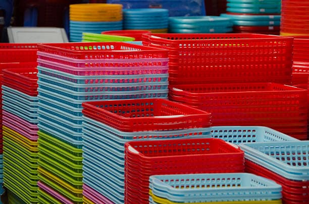 Stacks of plastic baskets in red, blue, and yellow